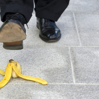 Businessman Stepping On Banana Skin, Copy Space Businessman Stepping On Banana Skin, Copy Space