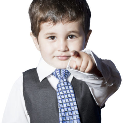 A Small Boy In The Studio, Dressed Up In A Suit And Pretending T A Small Boy In The Studio, Dressed Up In A Suit And Pretending T