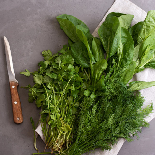 Fresh Green Vegetables: Spinach, Dill, Parsley, Cilantro On Textiles On A Gray Background, Healthy Food Concept. Fresh Green Vegetables: Spinach, Dill, Parsley, Cilantro On Textiles On A Gray Background, Healthy Food Concept.