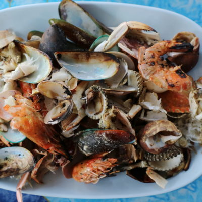 Shells Shrimp Shells And Crab Shells On White Plate In Seafood Restaurant Shells Shrimp Shells And Crab Shells On White Plate In Seafood Restaurant